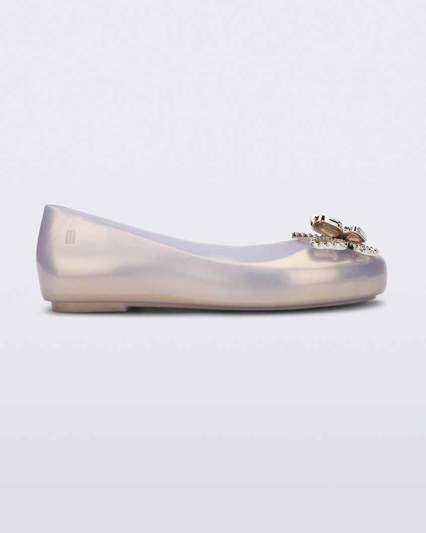 Side view of a pearly gold Mini Melissa Sweet Love Butterfly flat with a gold butterfly detail on the toe