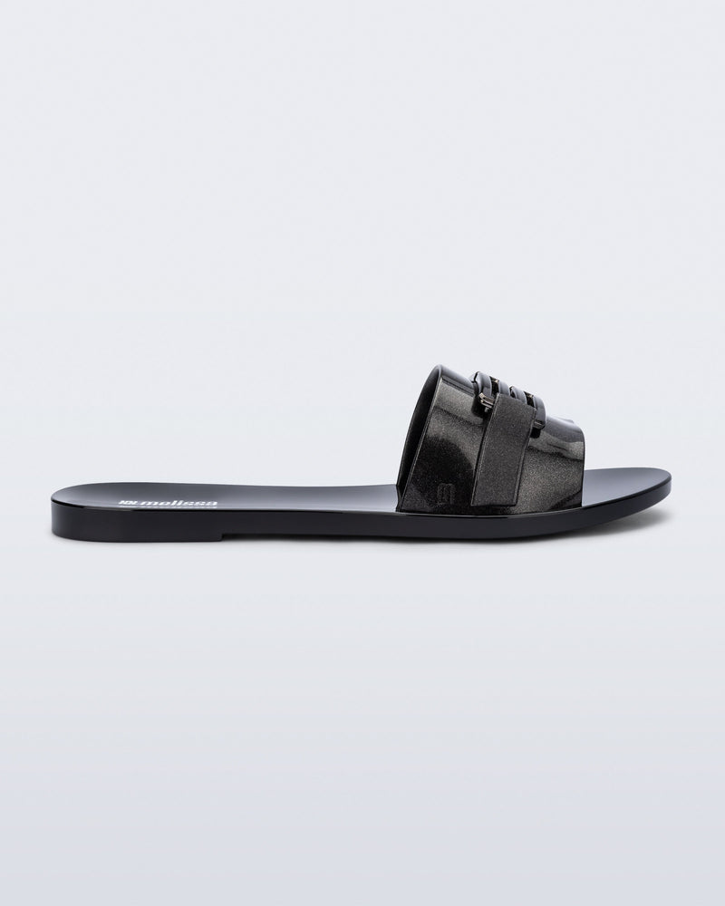 Side view of a black Babe M Chic slide sandal.