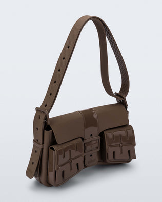 Angled view of a brown Cargo bag with two small pockets on the front and an adjustable strap