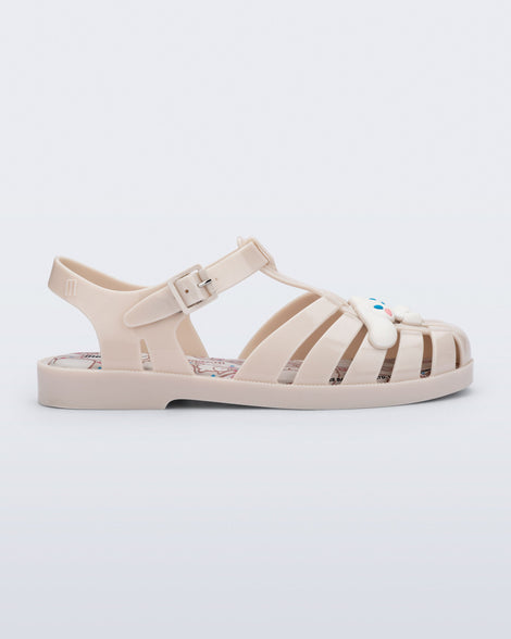 Side view of a beige Possession + Hello Kitty and Friends fisherman sandal with Hello Kitty and friends on the upper