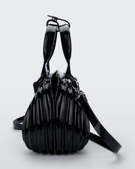 Side view of a black Quantum Dome + Diesel bag with hand strap and shoulder strap