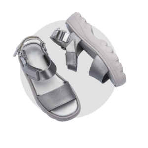 A pair of metallic silver platform sandals with adjustable straps, shown from different angles on a light gray circular background.