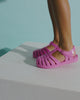 Video with no sound of a child's legs wearing a pair of pink Possession fisherman kids sandals.
