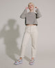 Video with no sound of a model in beige pants and grey shirt wearing a pair of blue Kick off sandals.