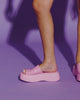 Video with no sound of a model in an orange dress wearing a pair of pink Becky platform slides.