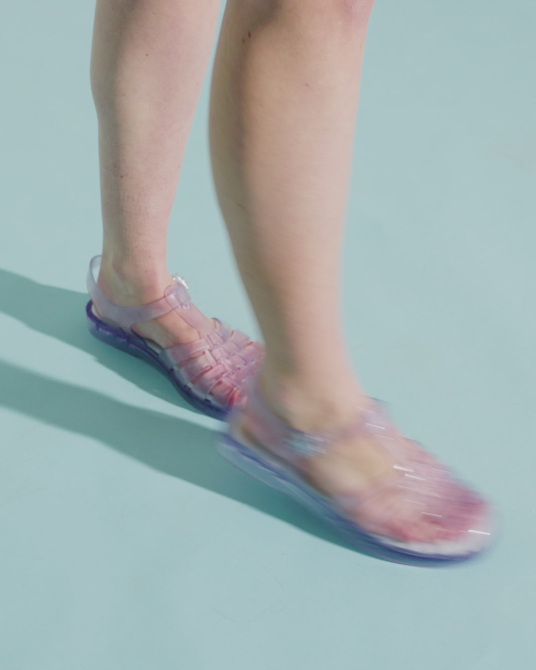 Video with no sound of a model's legs wearing a pair of clear Possession fisherman sandals.