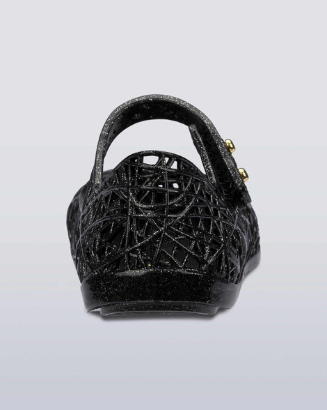 Back view of a Black/Silver Glitter Mini Melissa Campana Zig Zag flats with a top strap and a woven detail design.