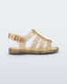 Side view of a clear yellow glitter Mini Melissa Flox sandal with straps.