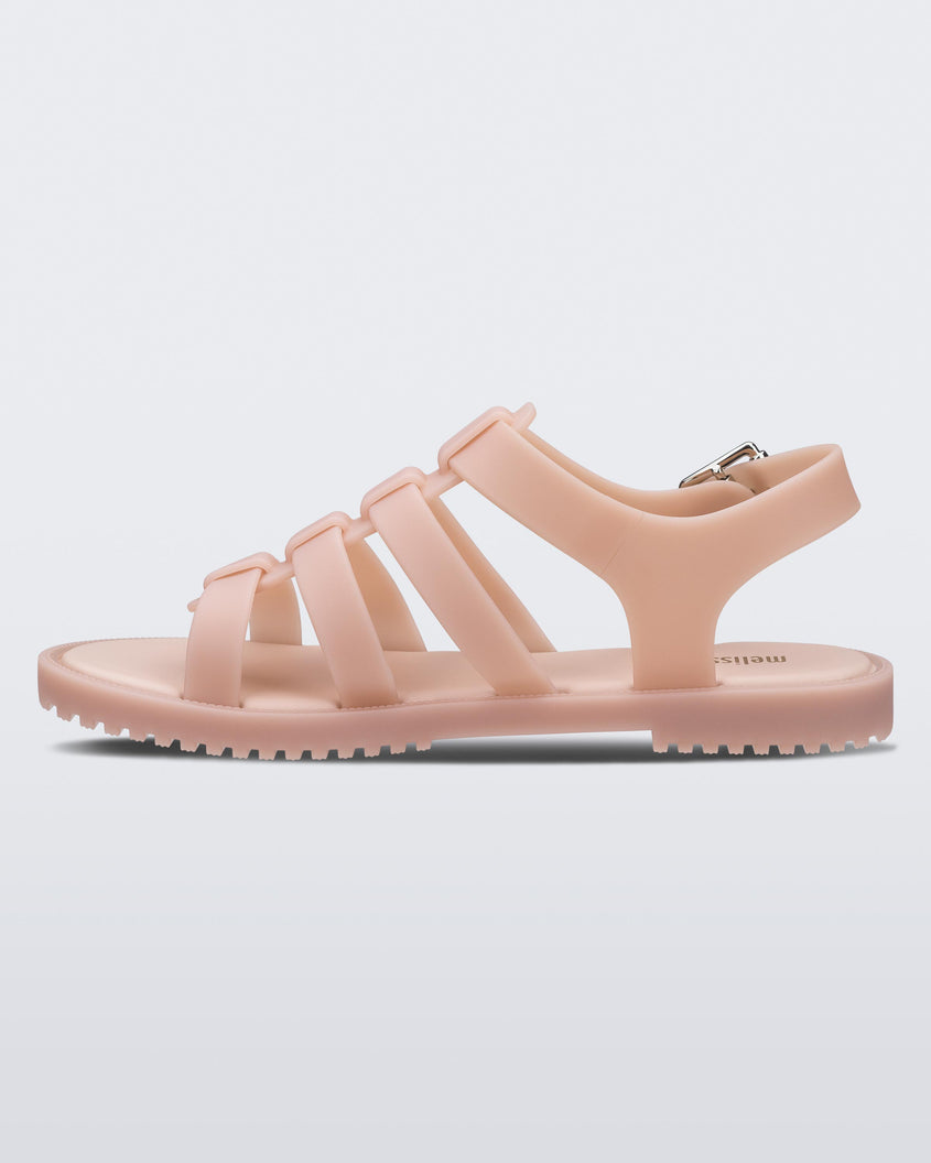 An inner side view of a pink Melissa Flox sandal with straps.