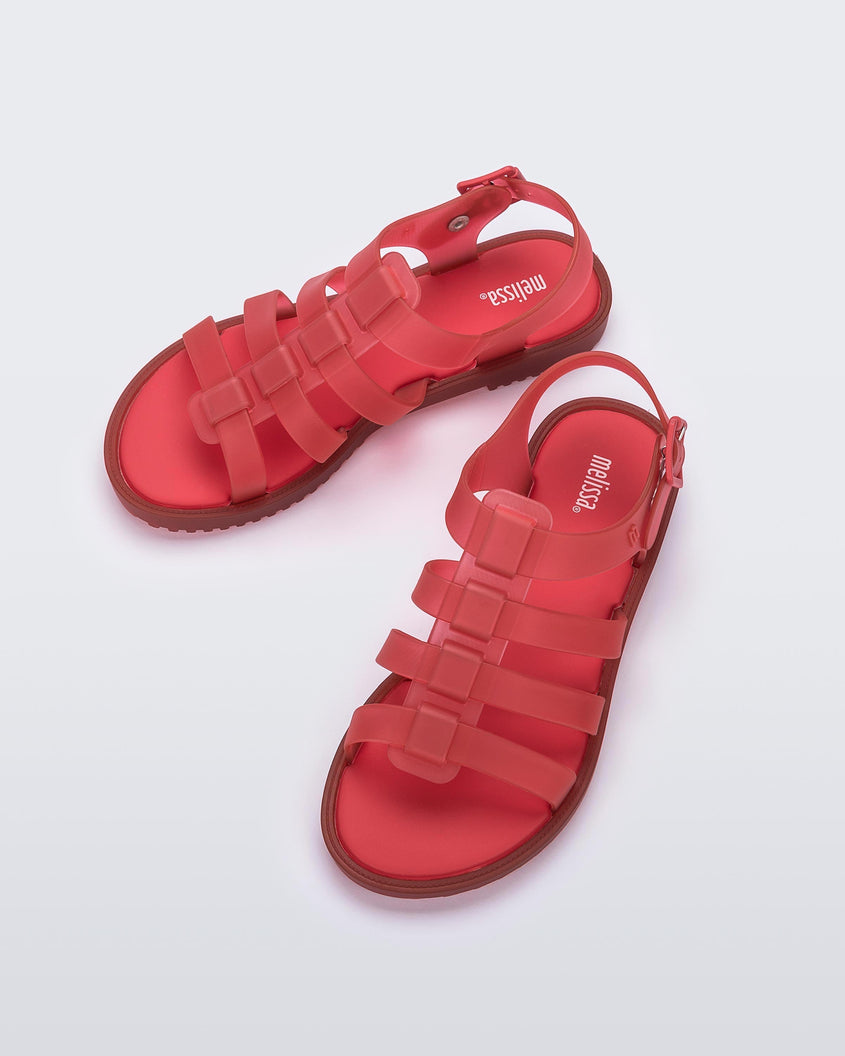 Top view of a pair of red Mini Melissa Flox sandals with straps with straps.