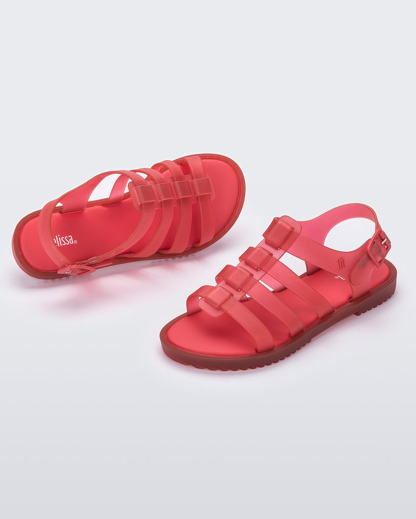 A top and side view of a pair of red Mini Melissa Flox sandals with straps.
