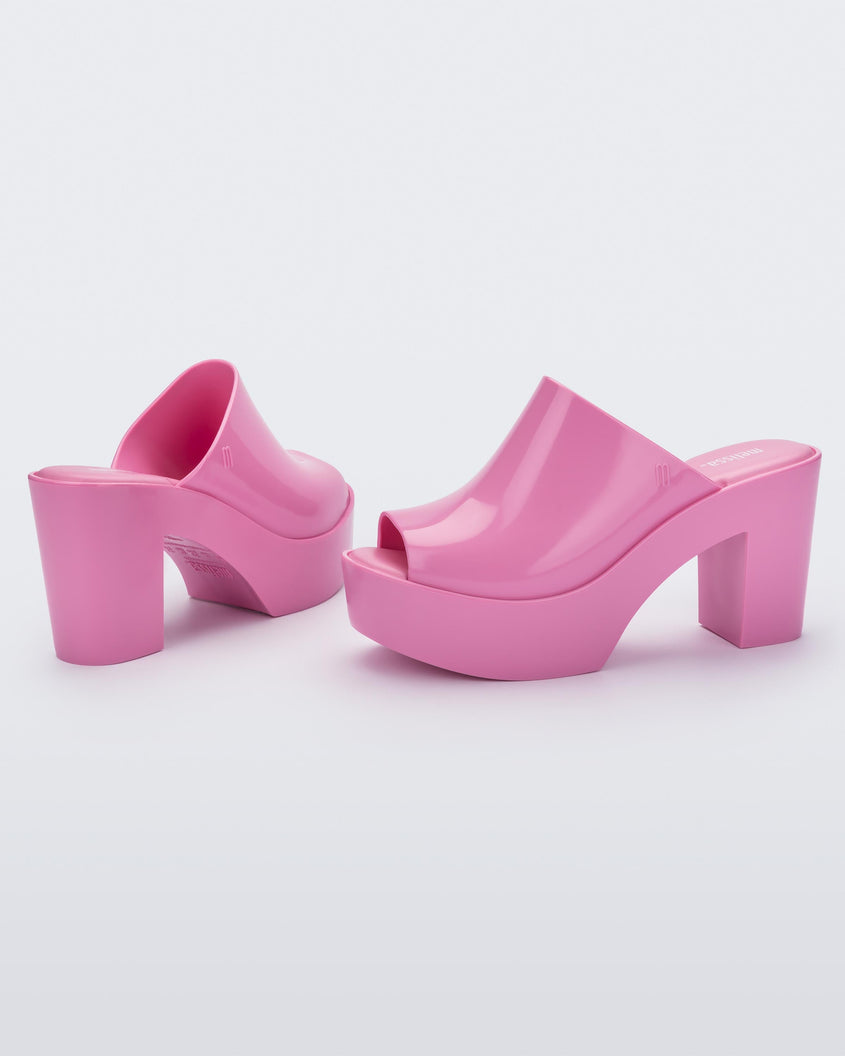 Angled view of a pair of pink Melissa Mule platform heels.
