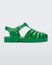 Side view of a green Mini Melissa Possession sandal with several straps and a green base.