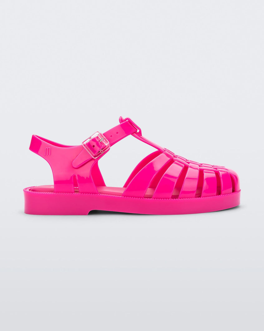Side view of an pink Mini Melissa Possession sandal with several straps, a closed toe front and a back ankle strap.