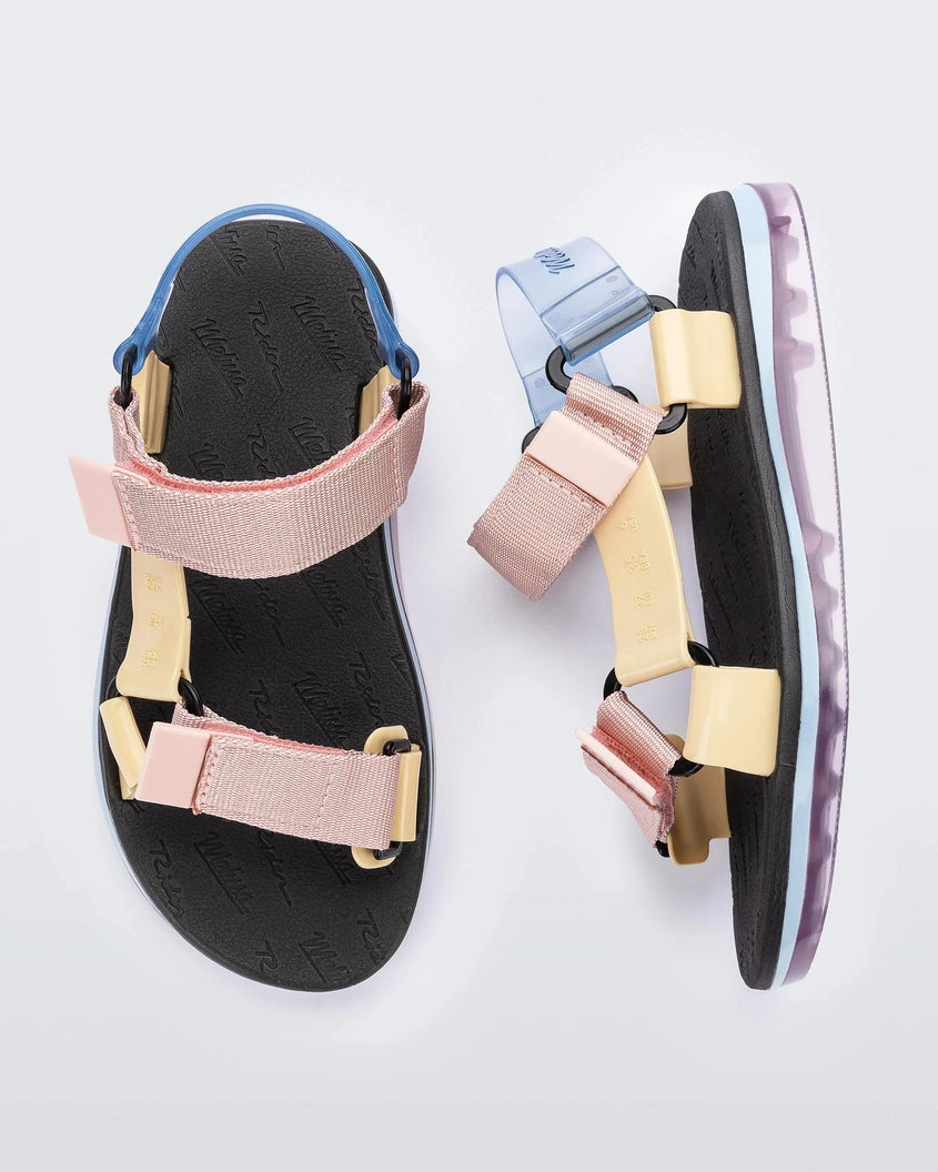 Side and top view of a pair of black Melissa Papete sandals with pink, beige and transparent blue straps.