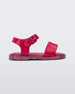 Side view of a pink/pink glitter Mini Melissa Mar Sandal with two straps in pink and a glitter sole.