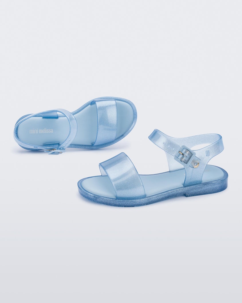 Top and side view of a pair of blue glitter Mini Melissa Mar Sandals.