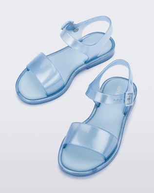 Angled view of a pair of blue glitter Mini Melissa Mar Sandals.