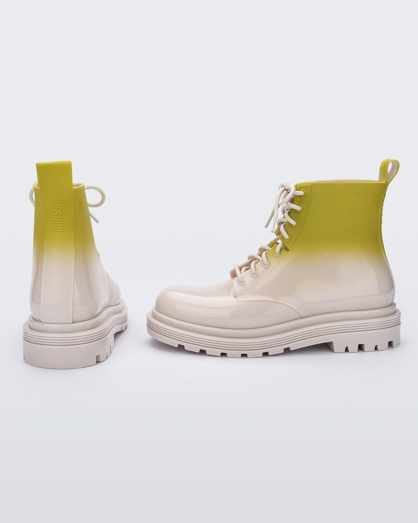 A back and side view of a pair of beige/green Melissa Coturno boots with a green into beige ombre base, beige laces and sole.