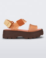 Side view of an orange/clear orange Melissa platform Kick Off sandal with two straps and a brown sole.