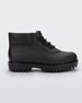 A side view of a matte black Melissa Ares combat boot with a black base, laces and tractor sole.