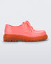 Side view of a pink / orange Melissa Bass sneaker with a pink base, pink laces and an orange sole.