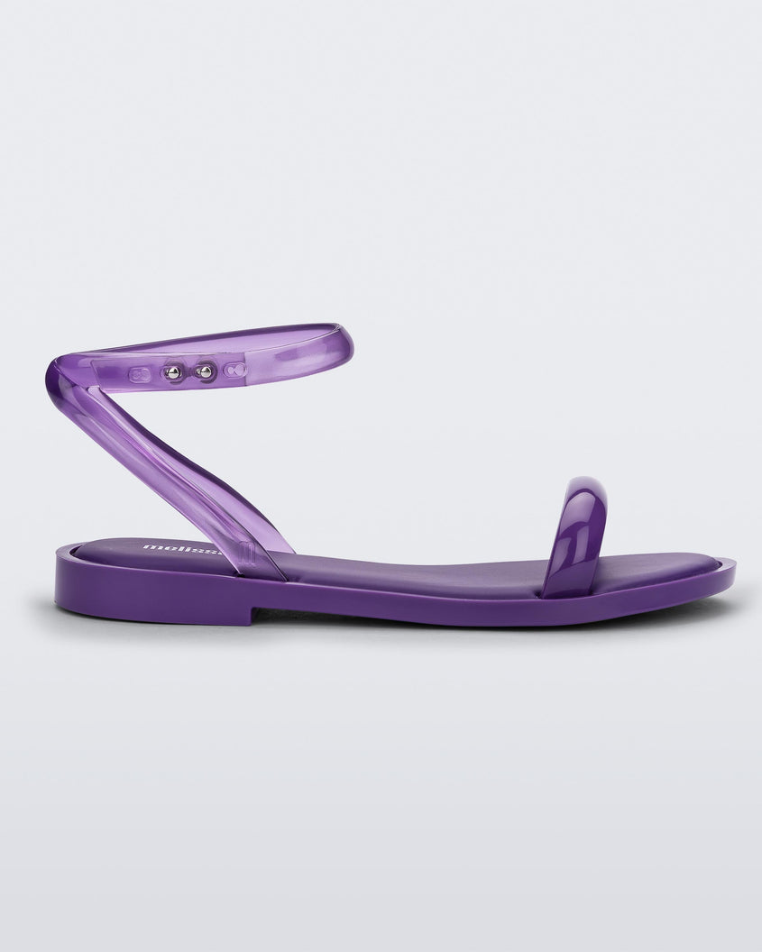 Side view of a purple Melissa Wave Sandal with a purple front strap and clear purple ankle strap.