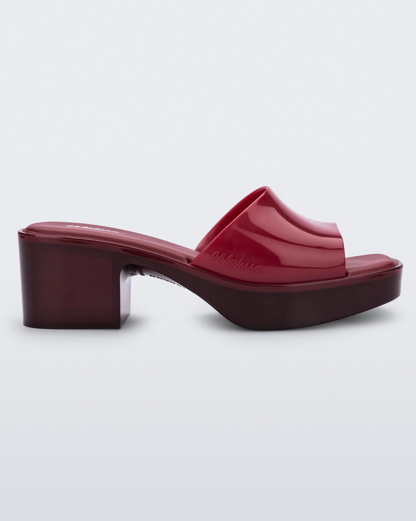 Side view of a Melissa Shape heeled slide in Red