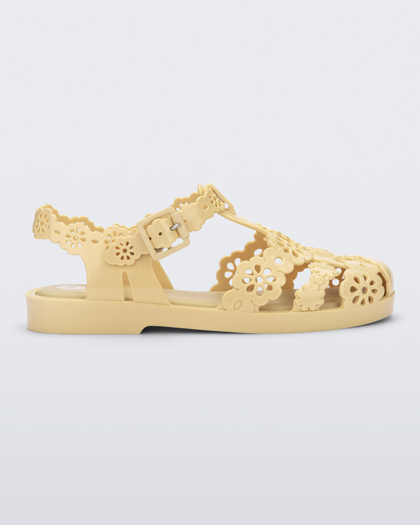 Side view of a Melissa Possession fisherman sandal in yellow with cut out lace detail on the straps.