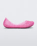Side view of a pink Mini Melissa Campana flat with a woven detail base.