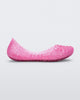 Side view of a pink Mini Melissa Campana flat with a woven detail base.