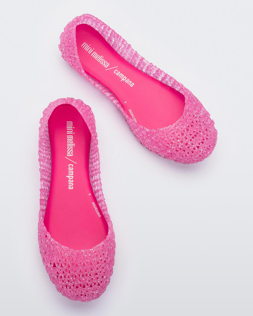 Top view of a pair of pink Mini Melissa Campana flats with a woven detail base.