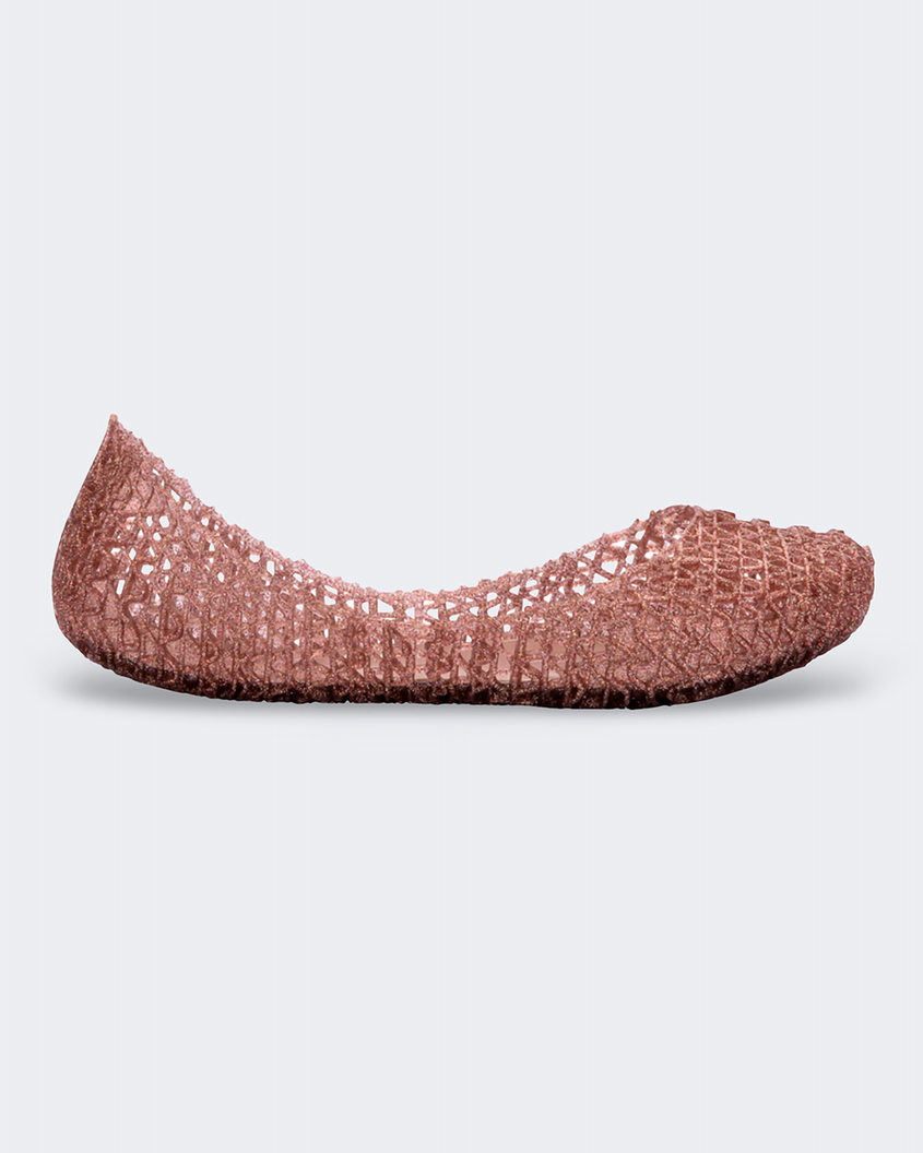 An outter side view of a rose glitter Mini Melissa Campana flats with a woven detail base.