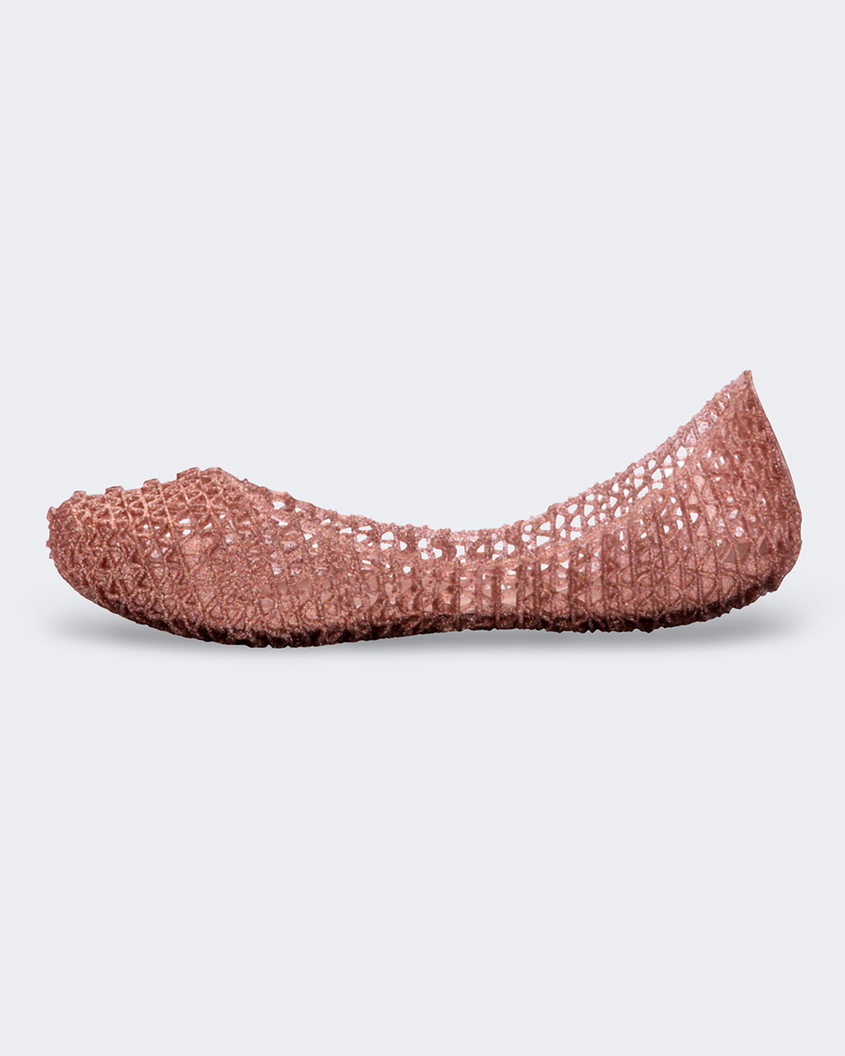 An inner side view of a rose glitter Mini Melissa Campana flats with a woven detail base.