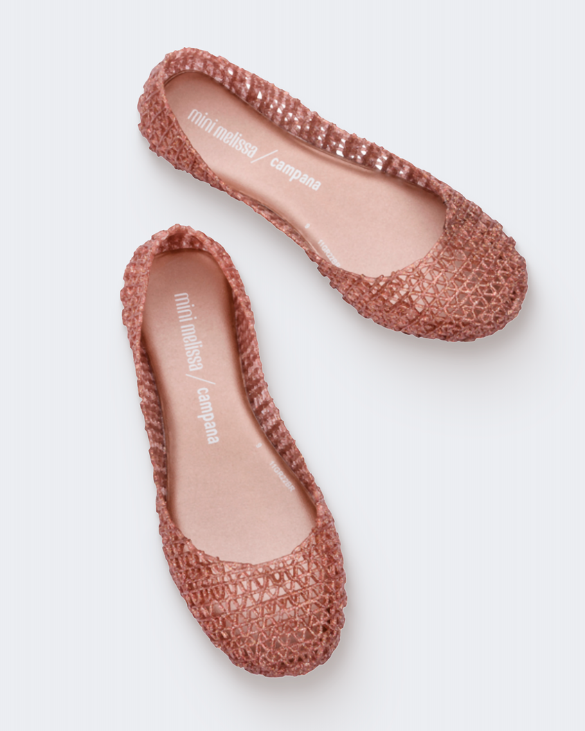 Top view of a pair of rose glitter Mini Melissa Campana flats with a woven detail base.