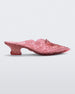 Side view of a clear pink Melissa Court heel heart detail on the front and a checkered pattern texture.
