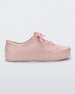 Side view of a pink Mini Melissa Street sneaker with a light pink base, laces and sole.