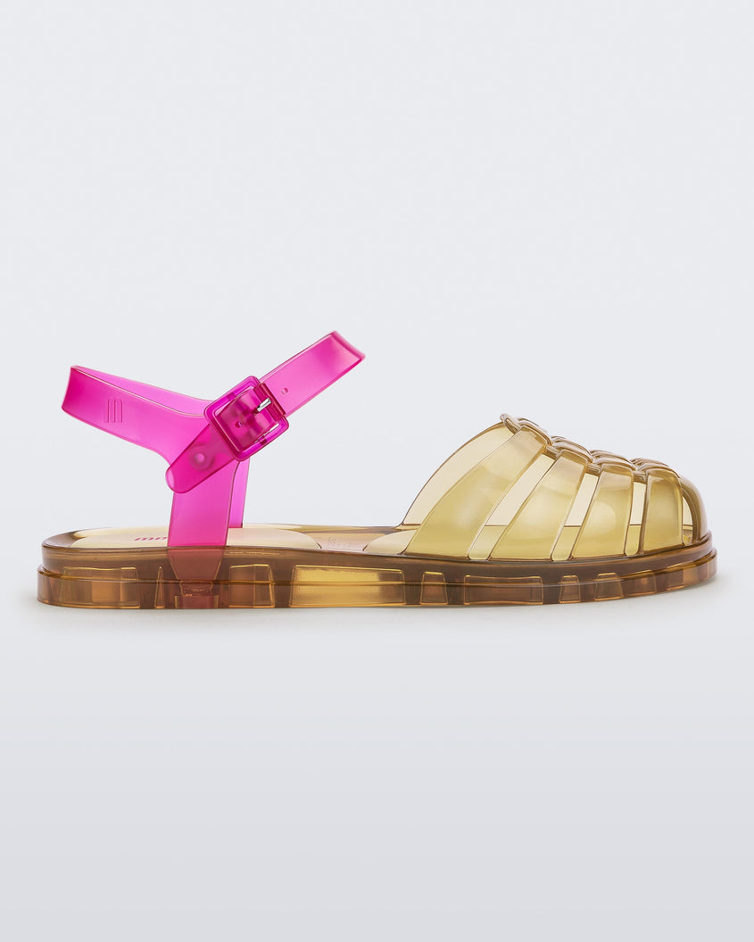 Side view of a transparent yellow and pink Melissa Obsessed sandal.