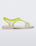 Side view of a beige/green Melissa Bikini sandal with two transparent green straps conjoining in the middle and a beige insole.