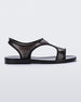 Side view of a transparent black Melissa Bikini Sandal with two transparent black straps conjoining in the middle and a black insole.