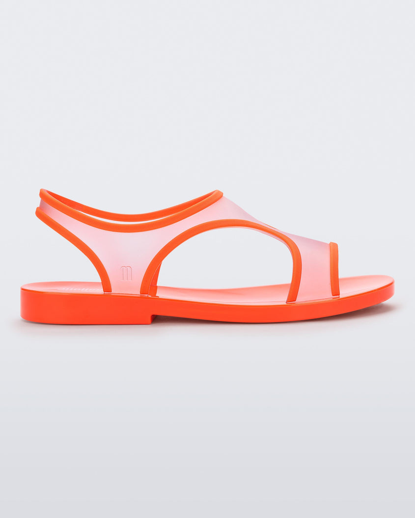 Side view of a transparent orange Melissa Bikini Sandal with two transparent orange straps conjoining in the middle and an orange insole.