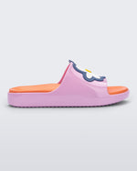 Side view of a pink/orange Mini Melissa Cloud slide with an orange insole, pink base and a flower detail on the front.