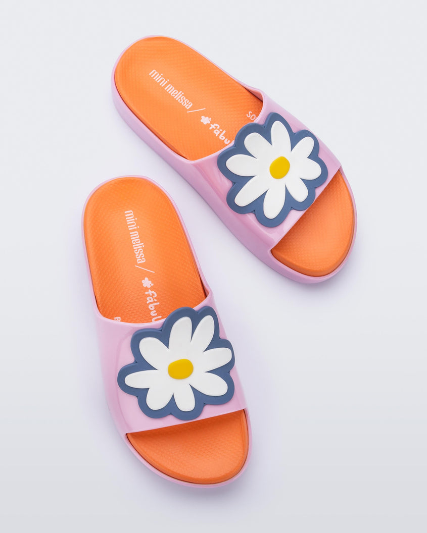 Top view of a pair of pink/orange Mini Melissa Cloud slides with an orange insole, pink base and a flower detail on the front.