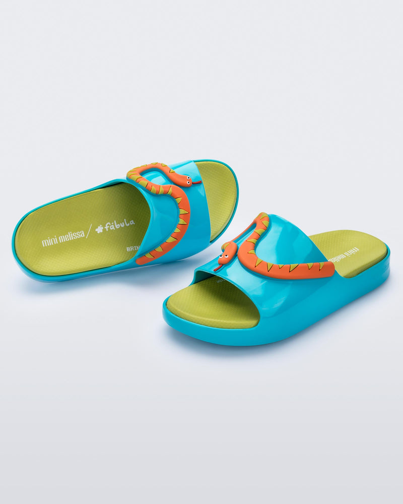 Angled view of a pair of blue/green Cloud + Fábula kids slides