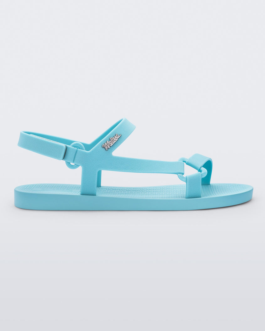 Side view of a Melissa Sun Downtown sandal with light blue front cross and back ankle straps.