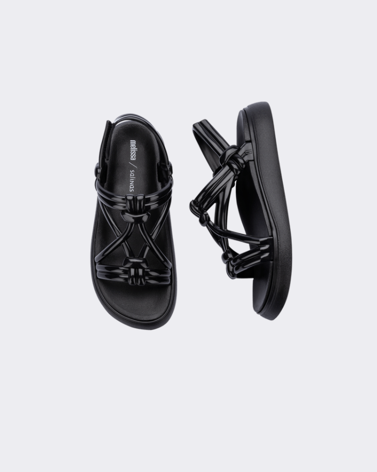 A top and side view of a pair of black Melissa Papete Essential sandals with straps.