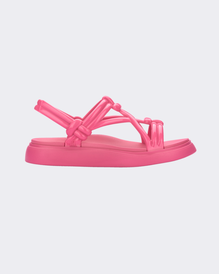 Side view of Melissa Papete Essential pink sandals with straps.