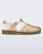 Side view of a beige glitter Melissa Possession Shiny sandal with several straps, a closed toe front and an ankle strap.