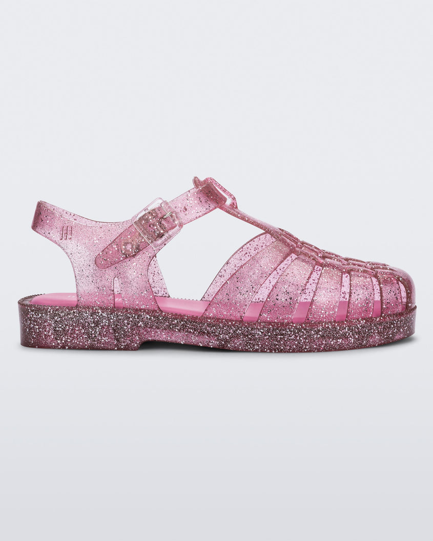 Side view of a Pink/Glitter/Silver Mini Melissa Possession Shiny sandal with several straps and a pink glitter base.