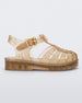 Side view of a Beige/Glitter/Gold Mini Melissa Possession Shiny sandal with several straps, closed toe front and an ankle strap.